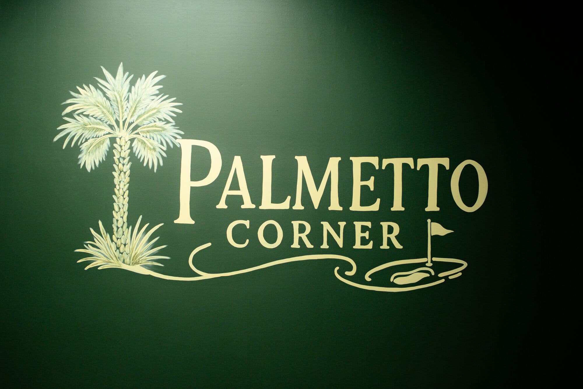 Gold Palmetto Corner bay sign on a dark green wall