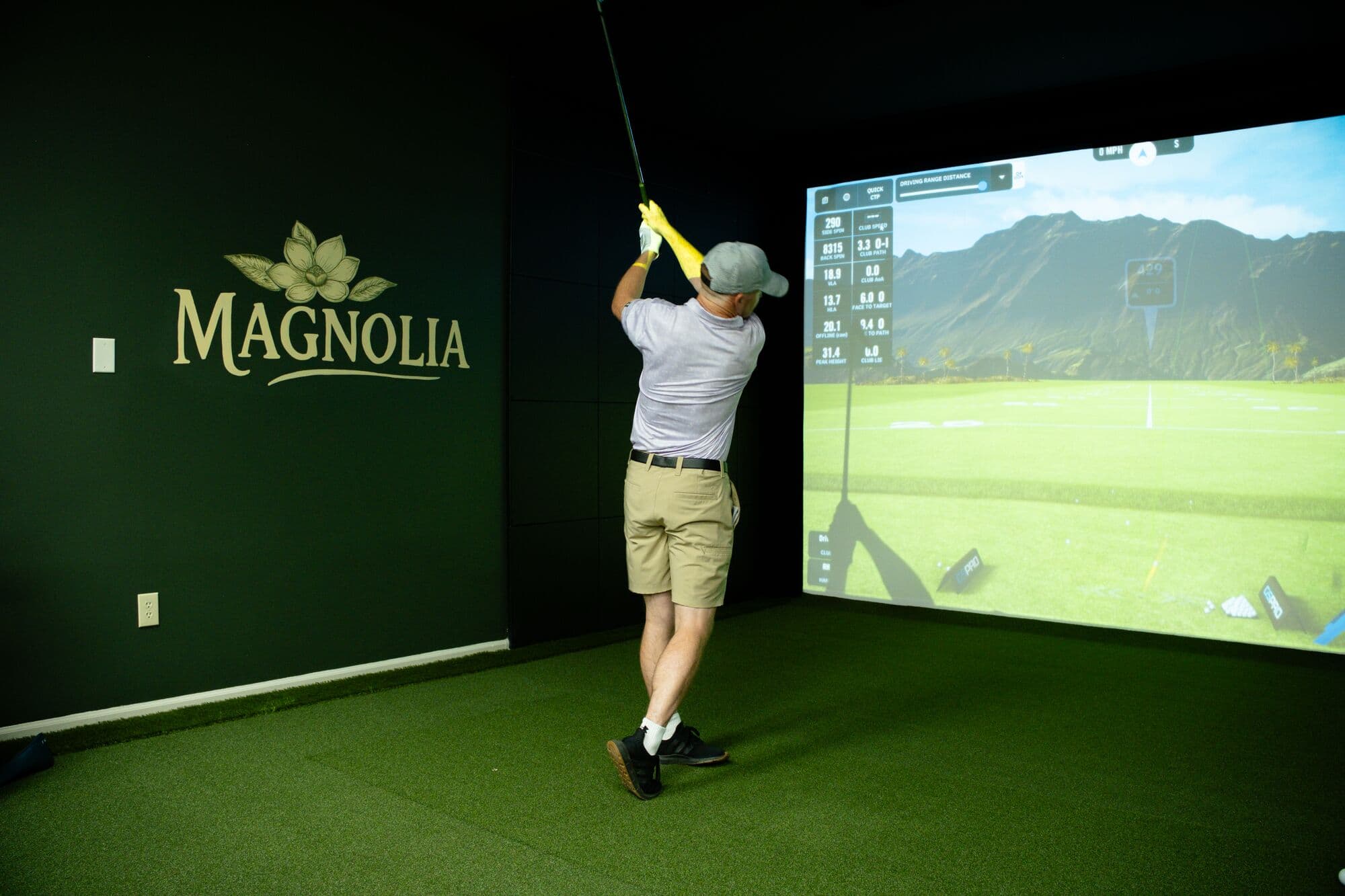 A golfer at the top of his backswing in the Magnolia bay