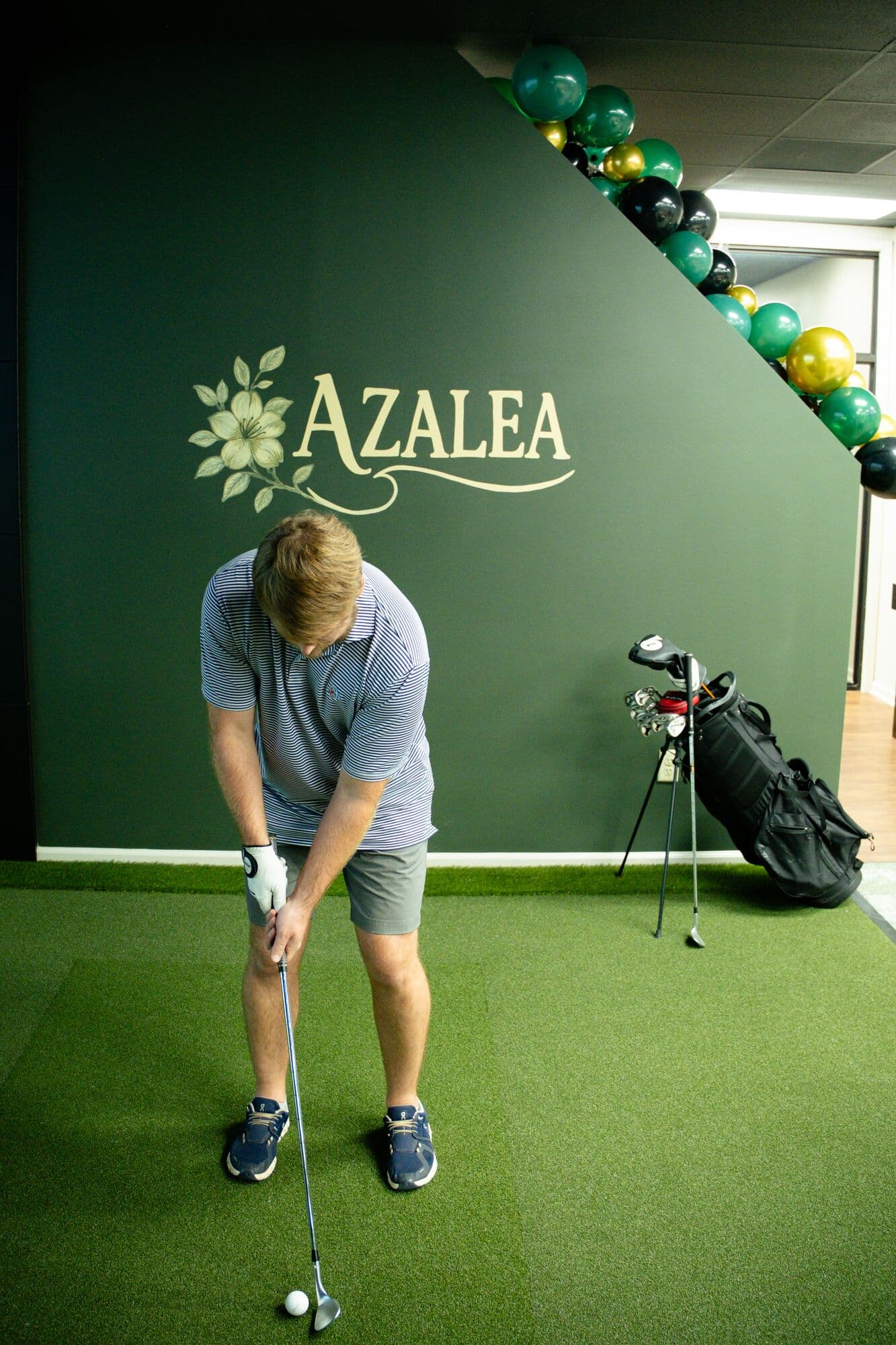 A golfer lining up a wedge shot in the Azalea bay
