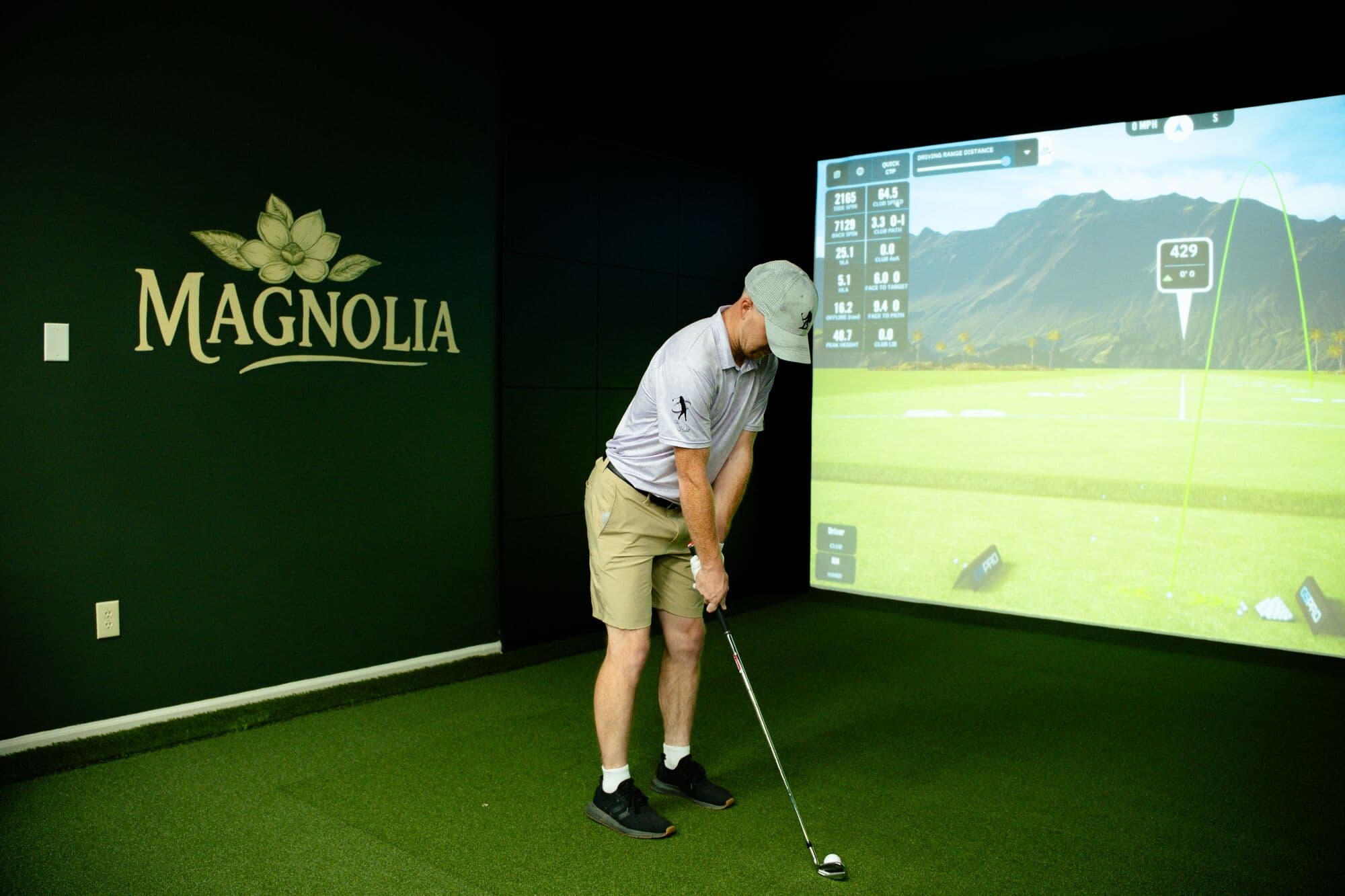 A golfer addressing the ball in the Magnolia bay